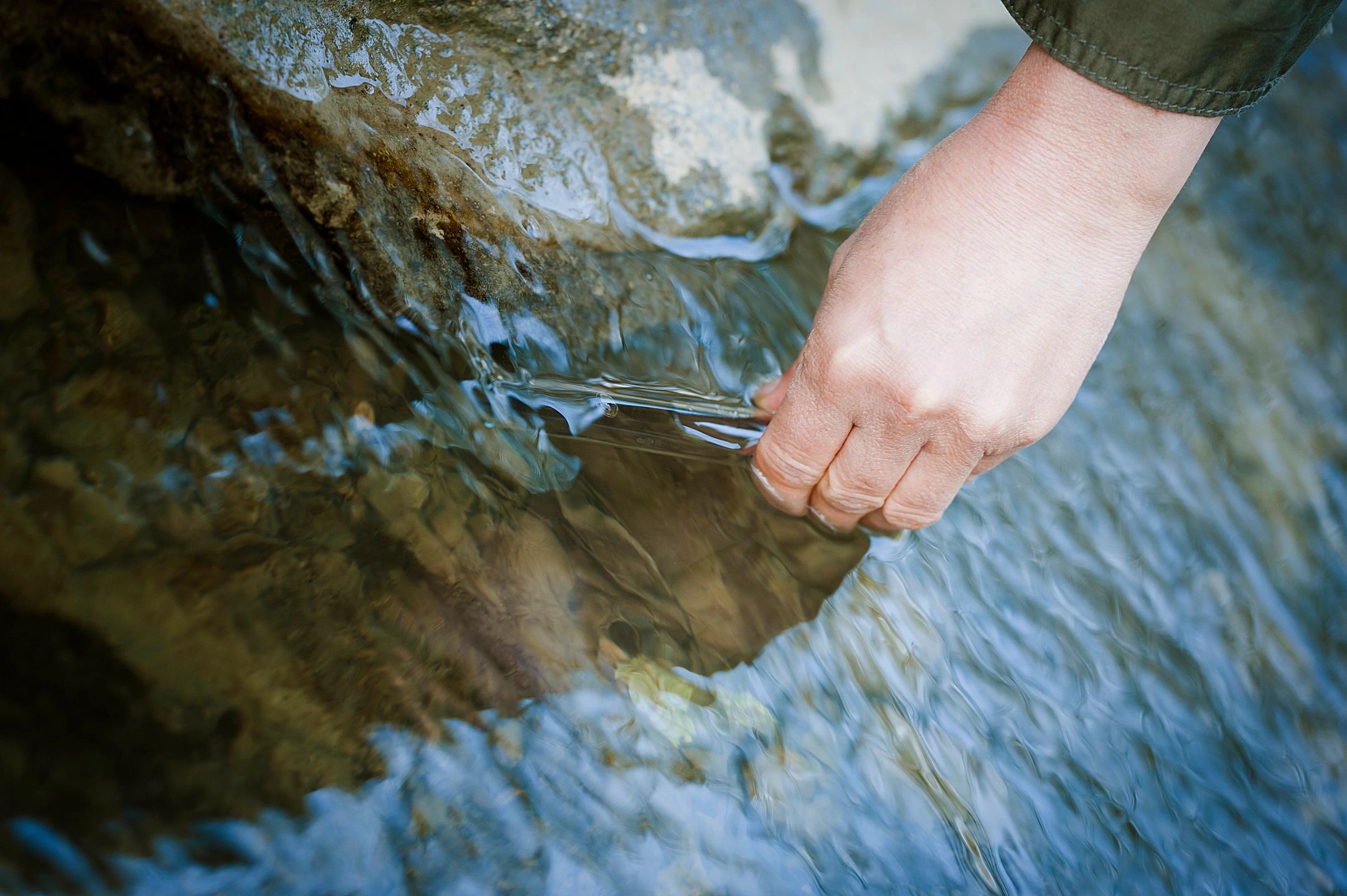 Field technician collecting water sample